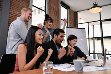 Business concept. Businessmen are shouting with joy. Business people are raising their hands for...
