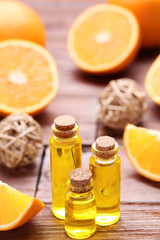 Orange oil in bottles on brown wooden table