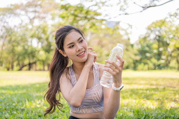 Exercise concept. Beautiful girl tired from exercise. Beautiful girl drinking water with thirst.