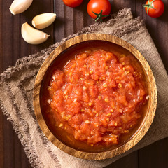 Homemade traditional Italian marinara or pomodoro tomato sauce made of fresh tomato, garlic, dried oregano and salt, photographed overhead with natural light (Selective Focus on the top of the sauce)