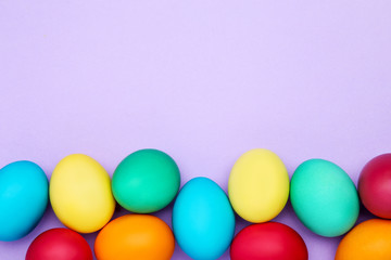 Colorful easter eggs on purple background