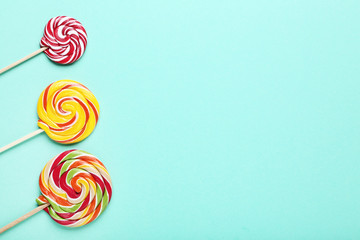 Fototapeta na wymiar Colorful lollipops on mint background