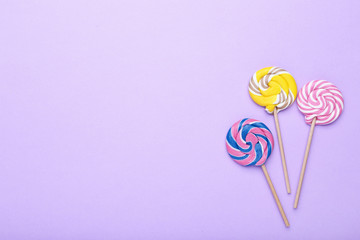 Colorful lollipops on purple background