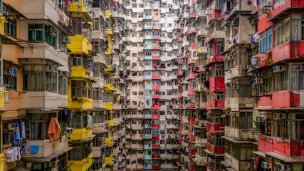 Aerial view of Yick Fat Building, Quarry Bay, Hong Kong. Residential area in old apartment with windows. High-rise building, skyscraper with windows of architecture in urban city. - obrazy, fototapety, plakaty