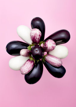 Overhead view of eggplants against pink background