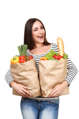 Beautiful woman holding grocery shopping bags on white background