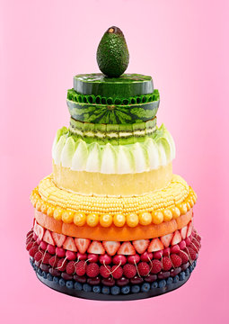 Cake made of variety of fruits against pink background