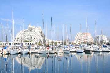Pyramids buildings and pleasure boats in the seaside resort and marina  of la Grande Motte in Herault department, France