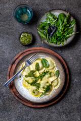 Italian spinach ricotta ravioli, Top view, black background, copy space, Vegetarian food, vegan ravioli