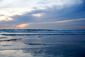 Fototapeta na wymiar Beautiful colorful sunset over the beach and sea. Beautiful sky twilight time and reflection on the sea. peaceful moment. San Elijo State Beach, Encinitas, San Diego, California