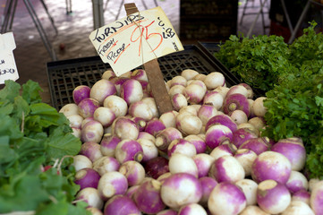 white and purple turnips vegetables at the market