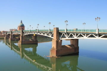 The Saint Pierre bridge passes over the Garonne river and Hospital de La Grave in Toulouse, the...