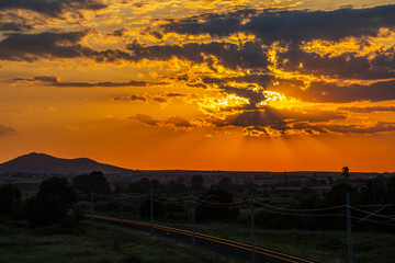 Beautiful summer sunset over sunlit empty railway tracks near Krum, Southern Bulgaria, elevated view from a bridge