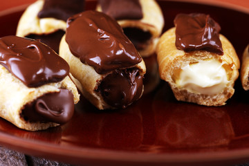 Traditional French dessert. Eclair with chocolate icing. Pastery concept with chocolate eclair