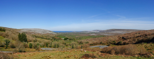 Panoramic view, Burren region, Atlantic ocean in the background, Sunny day, Clear sky, Concept discover Ireland, Wild Atlantic Way route.
