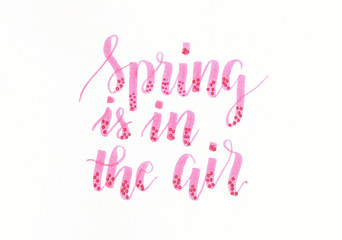 Spring is in the air - hand lettering inscription in pink with dots