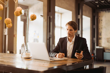 Young handsome businessman conducting negotiations with investors. Electronic business. Alternative...