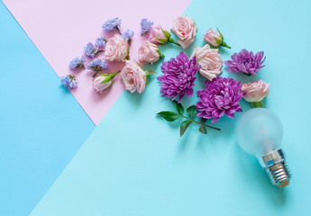 Concept, flowers and  cup for coffee or tea, notebook for records and smartphone on  blue and pink background, minimalism and idea.