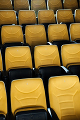 rows of empty orange comfortable seats in cinema hall