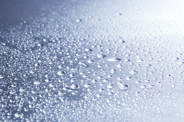Fototapeta na wymiar Drops of water on a gray background closeup