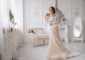 A magnificent bride tries her dress on her wedding day