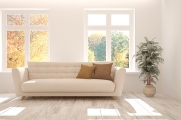 White stylish minimalist room with sofa and autumn landscape in window. Scandinavian interior design. 3D illustration