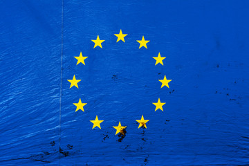 Image of the flag of European Union on the dirty, bright canvas tent wall