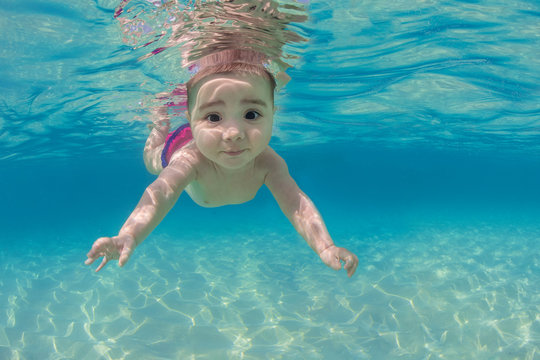 Portrait of boy swimming underwater in sea