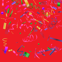 Colorful colored confetti on a red background. 