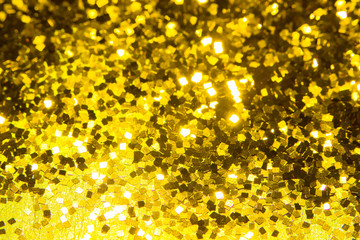 Gold glitter texture. Festive sparkling sequins background. Wpaper for Valentine, New Year or Christmas Holidays.