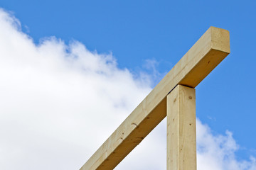 Naklejka premium Wooden beams against the blue sky. Wood as a universal building material.