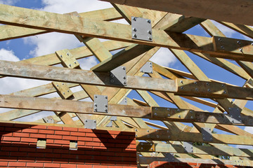 Roof structure in the new house. Bolting of wooden beams.