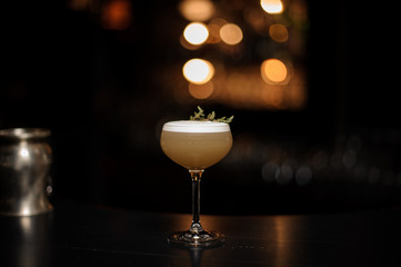 Light brown cocktail on a bar counter