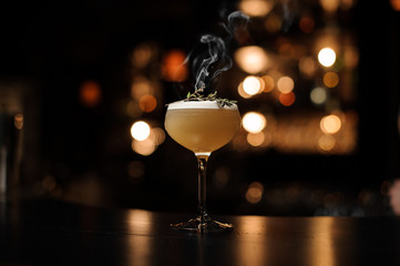 Light brown cocktail on a bar counter