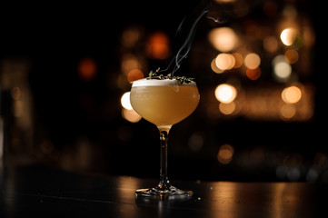 Light brown cocktail on a bar counter