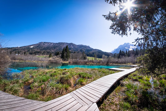 Lake Zelenci with observation trail and ponce mountains in Slovenia