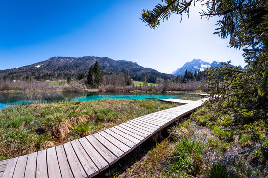 Lake Zelenci with observation trail and ponce mountains in Slovenia