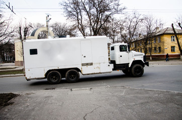 Armored truck, collectors, mail. White protected car in the city