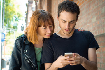Young couple using application on smartphone