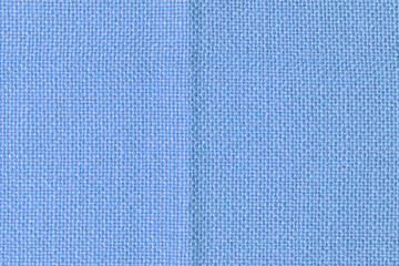 Abstract blank background for layouts. Coarse blue textile close up. Light photo.