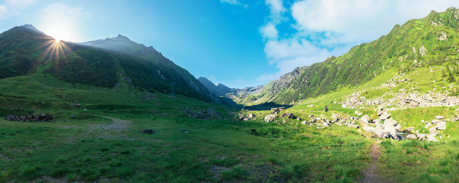 gorgeous valley of fagaras mountains in summertime. amazing landscape of romania at sunrise. location between transfagarasan road and balea creek. high peaks in the distance