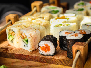 Sushi rolls different taste, rainbow color (fresh seafood) serving. Food background. Top view