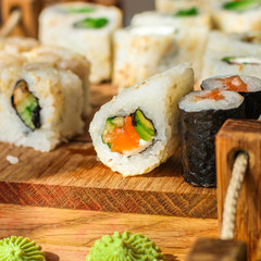 Sushi rolls different taste, rainbow color (fresh seafood) serving. Food background. Top view