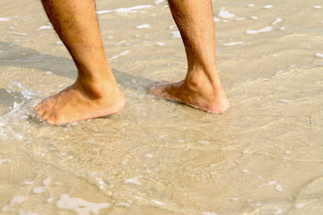 Human feet walking on the beach,tourist relax on summer holiday.