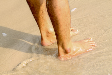 Human feet walking on the beach,tourist relax on summer holiday.