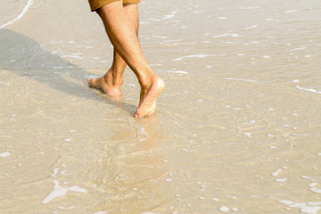 Human feet walking on the beach,tourist relax on summer holiday.