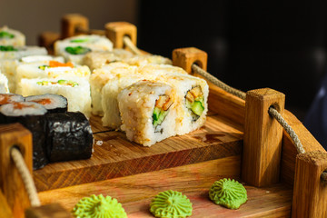Sushi rolls different taste, rainbow color (fresh seafood) serving. Food background. Top view