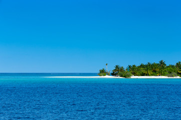 tropical Maldives island with white sandy beach and sea
