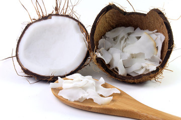fresh coconut flakes and chips placed in bark isolated on white background