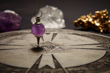 Properties of fortune telling - wooden spiritual chart and pendulum
